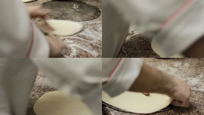 特写厨师手工制作披萨面团。