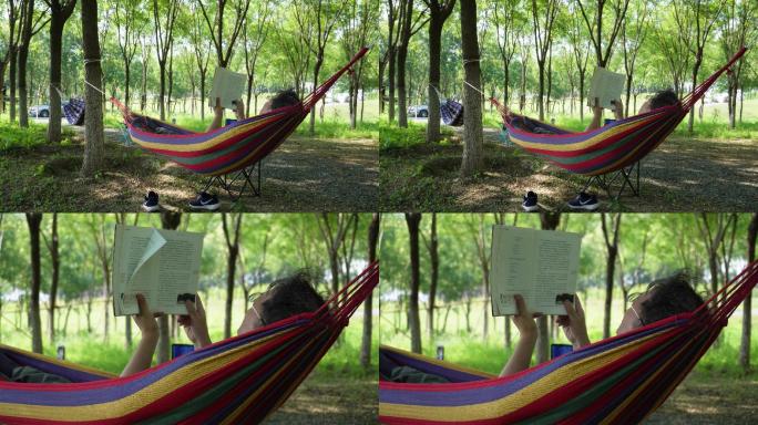 炎热夏季在户外树林吊床上休闲看书的男人