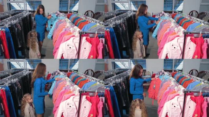 母亲和女儿在服装店买衣服，挑选夹克
