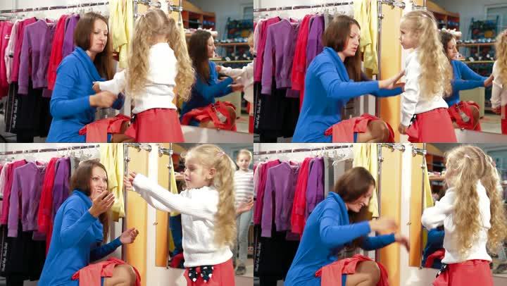 母亲和女儿在服装店买女孩的衣服，试穿上衣和裙子
