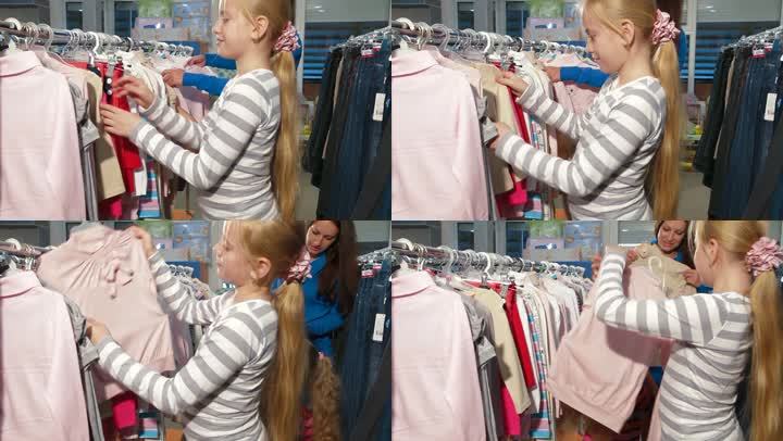 母亲和两个女儿在服装店买衣服