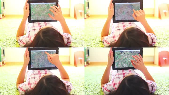 少女在数字平板电脑上搜索地图