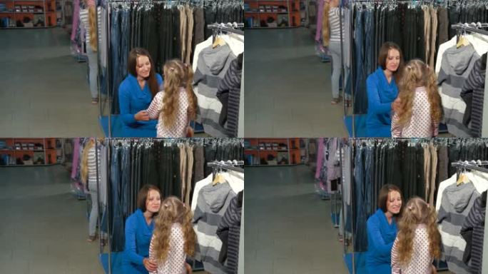 母亲和两个女儿在服装店买衣服