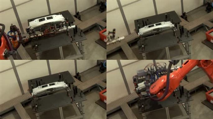 两个工业机器人组装汽车零件的图片。工厂中的液压操作机械臂。