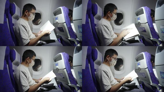 疫情期间男子在飞机上看书学习