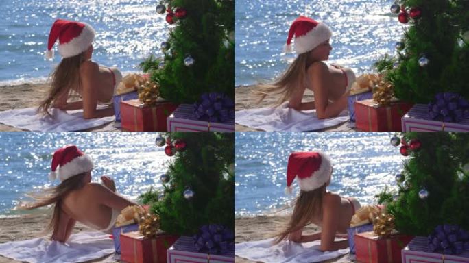 戴着红色圣诞帽的女孩在热带海滩