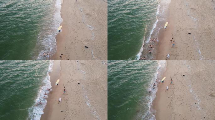 海滩上拿冲浪板的人