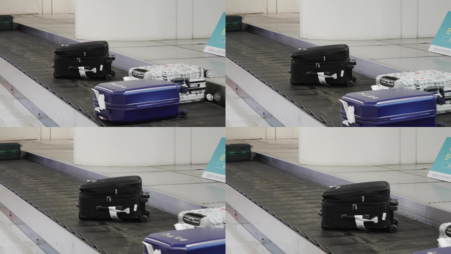 机场大厅内行李自提处传输带上的行李箱