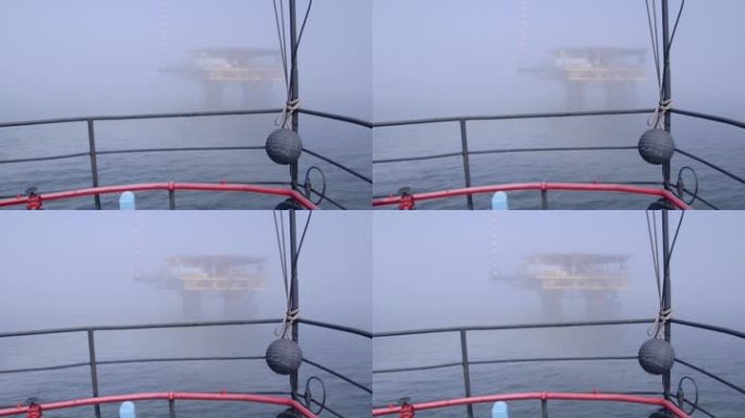 船舶驶向雾海中的海上天然气平台