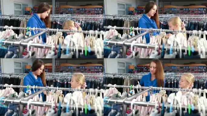 母亲和女儿在一家服装店为女孩买衣服，背景为焦点