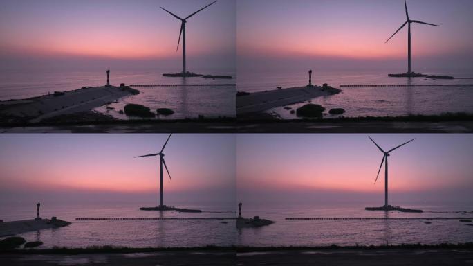 日出时分海边的风力发电机