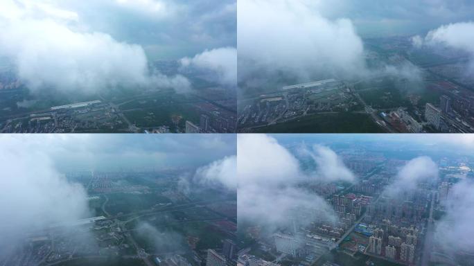 航拍云雾中的高铁和新城建筑物楼群