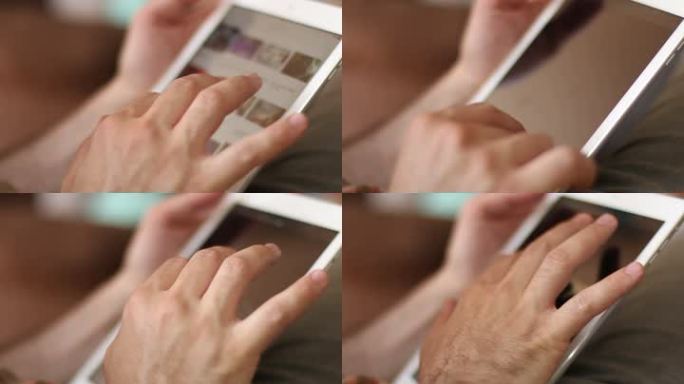 一个男人双手触摸平板电脑屏幕并浏览