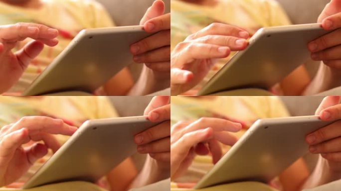 一个男人用他的Ipad上网。双手触摸平板电脑屏幕并浏览。闲暇时间触摸Ipad。