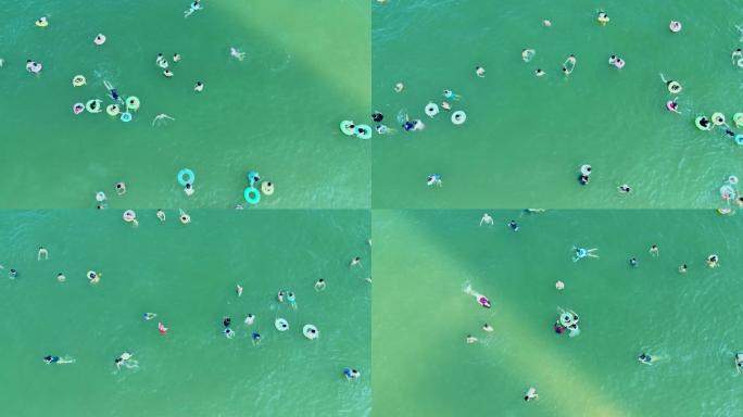 海滨城市夏天碧海中人们度假欢乐游泳航拍