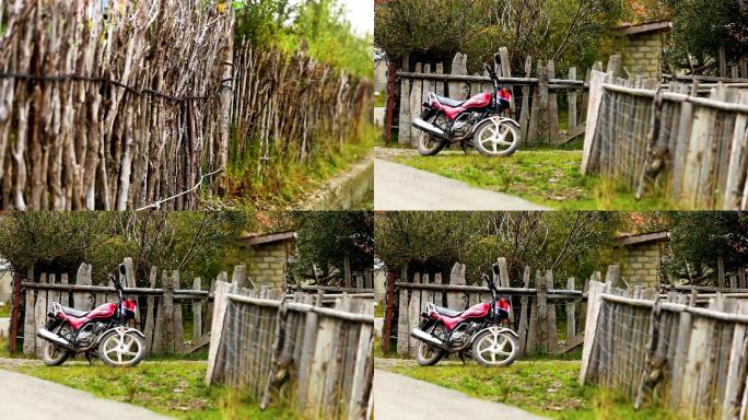 藏族民居前的摩托和原始木质栅栏
