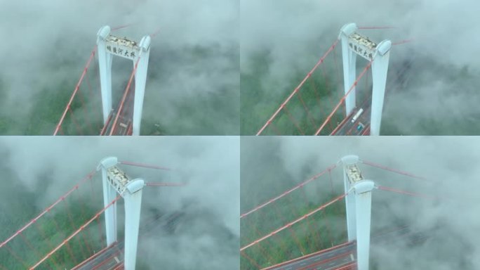 航拍云雾中的大桥上行驶的车辆