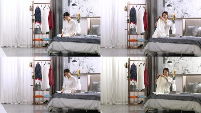【4K】生活家居年轻女人在床上整理衣服
