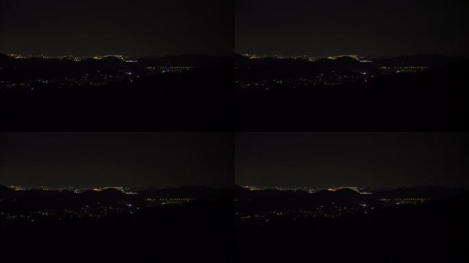 鸟瞰远处城市夜景旋转的光束
