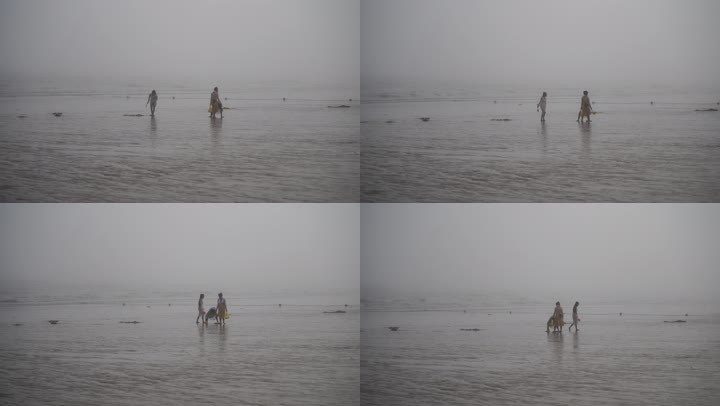 游客海边赶海阴雨天雾天阴天大海沙滩挖海鲜