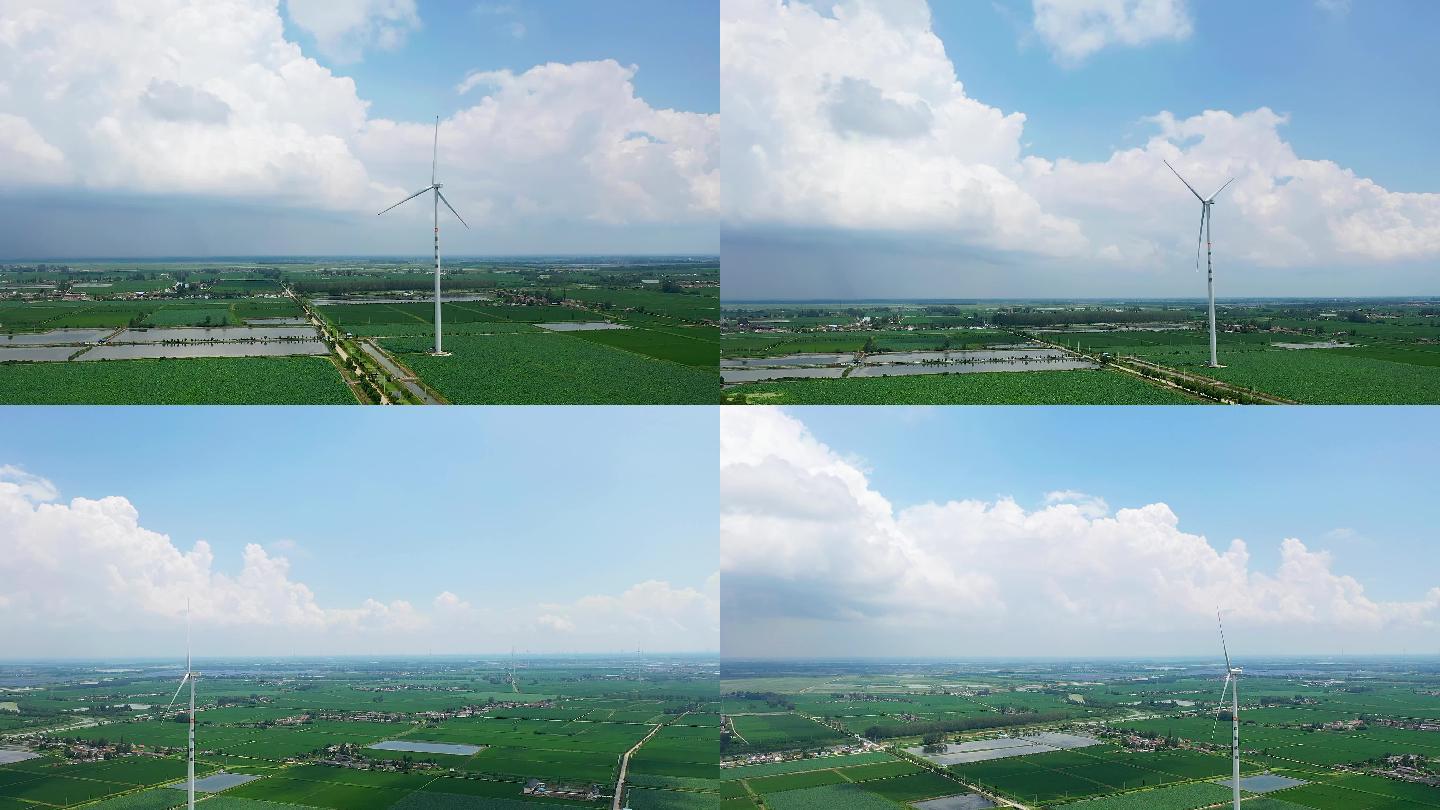 夏天大片农田里伫立的风力发电机
