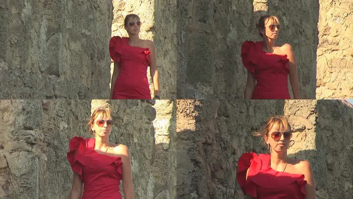 穿红衣服的女人穿过城堡的墙壁