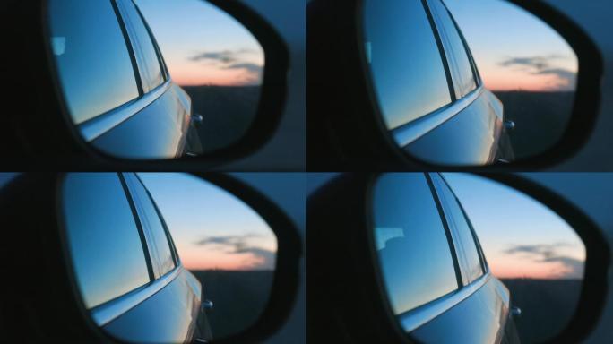 从汽车后视镜看车外夕阳