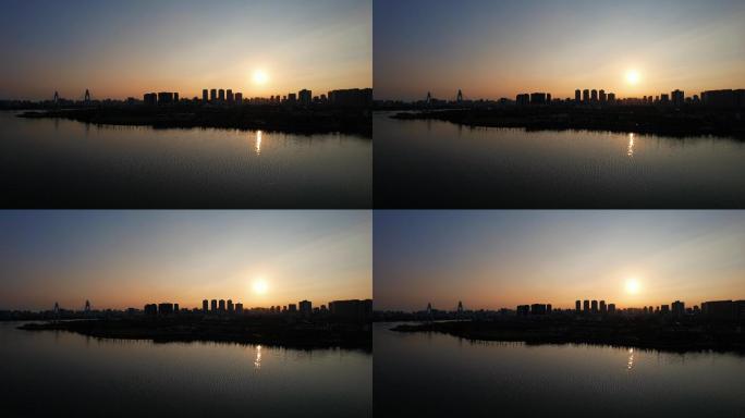 海南自贸港海口清晨日出城市建筑剪影航拍