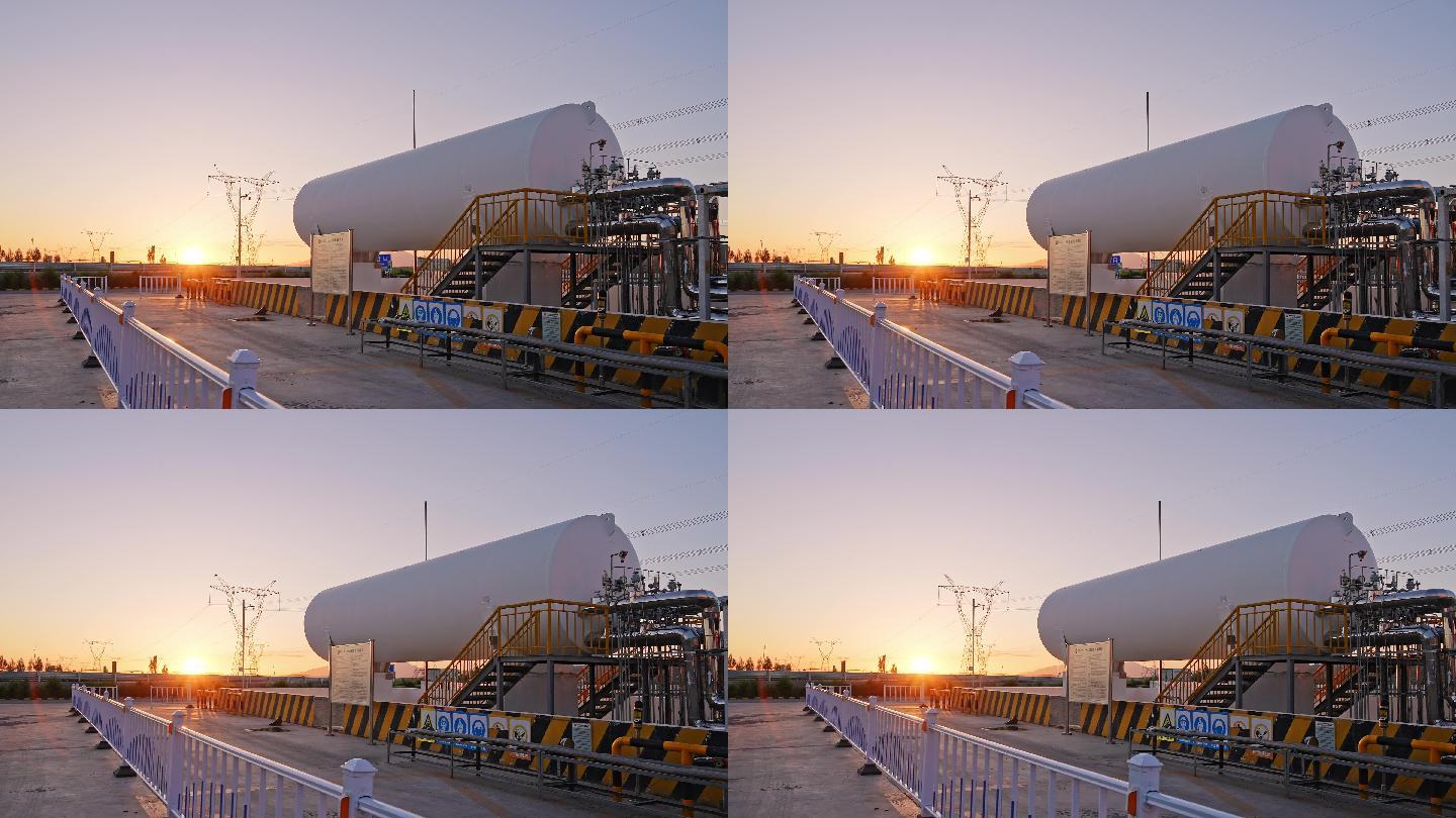 夕阳下高压电线塔附近巨大的LNG罐航拍
