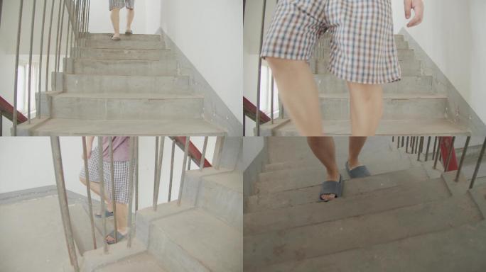 中年男人腿疼脚疼行动不便艰难爬老旧楼梯
