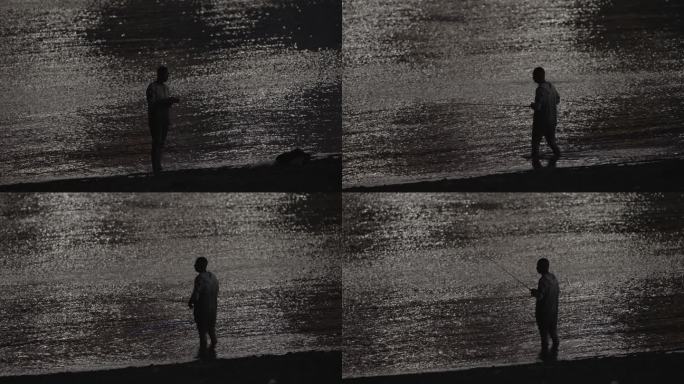 长江边的夜钓者，站在江水里甩杆钓鱼