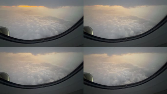 穿越云层的飞机舷窗外的傍晚自然风光