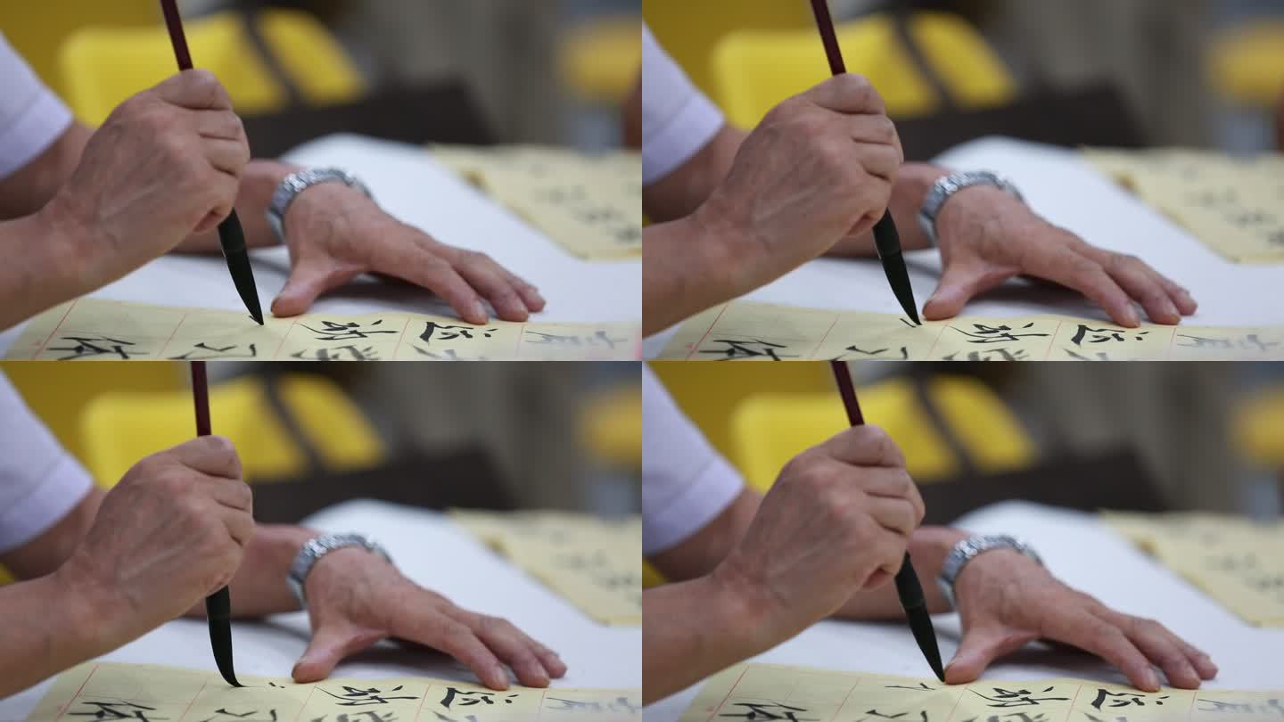 老年大学书法培训班老人手拿毛笔练字书法