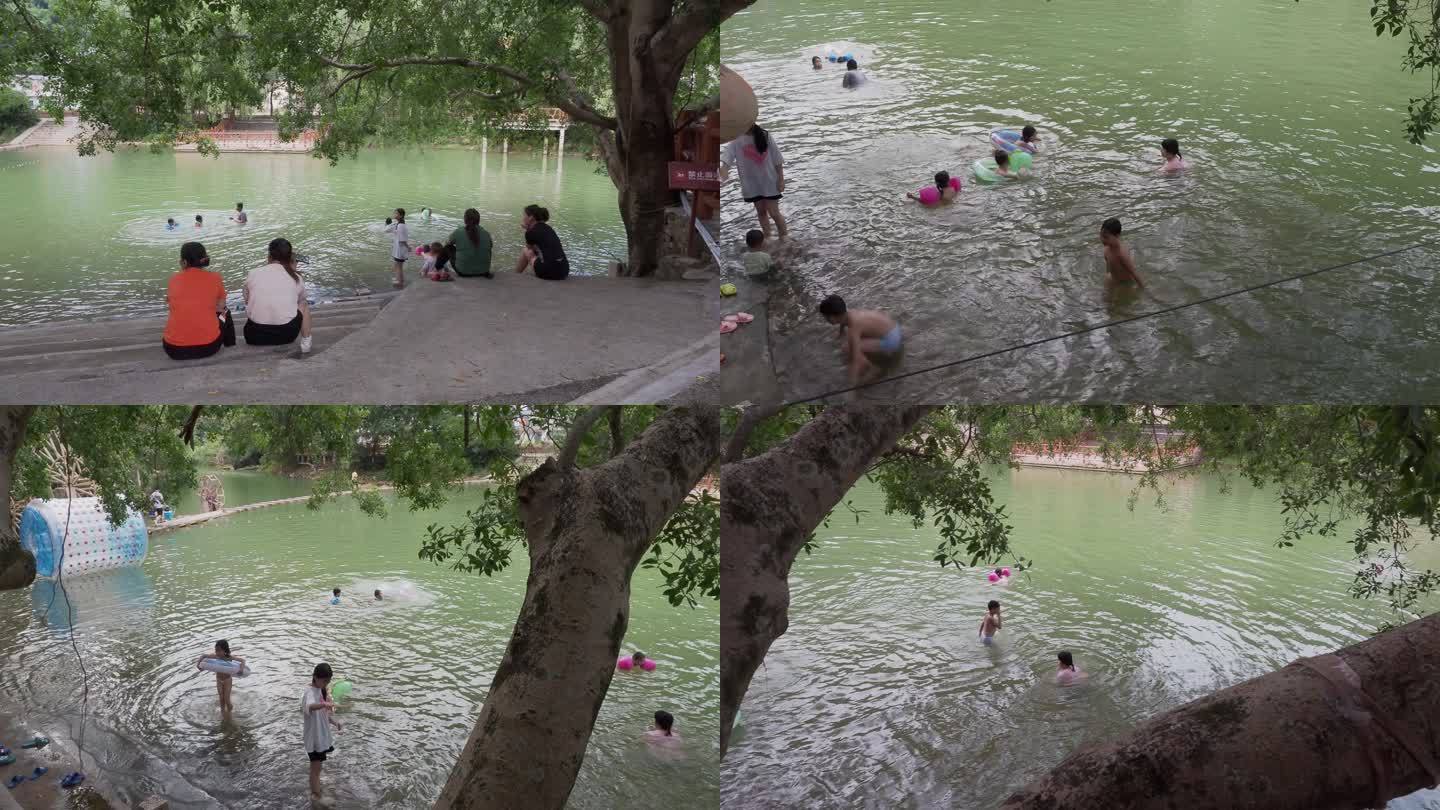 河边玩水游泳家长看护孩子在河里游泳