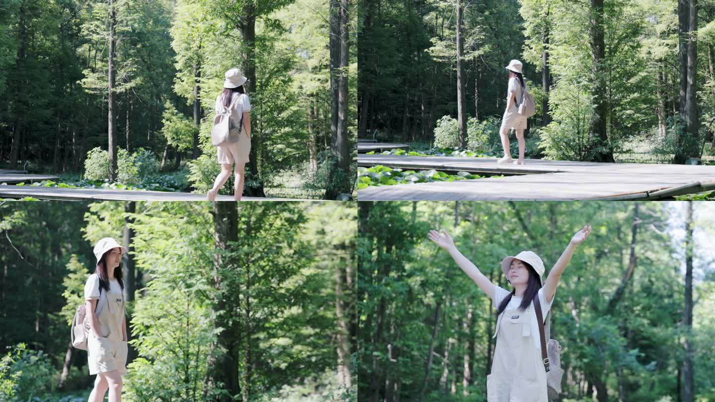 4K年轻女性背包在森林公园伸手享受自然