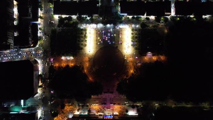俯瞰夜晚城市广场娱乐民生玩具车广场舞