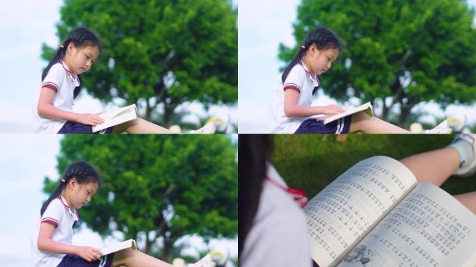 小女孩坐在草地上看书-唯美升格镜头