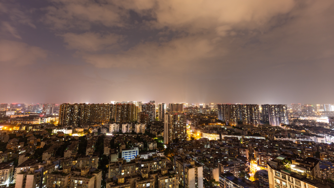 城市地平线日转夜城市亮灯万家灯火变焦延时