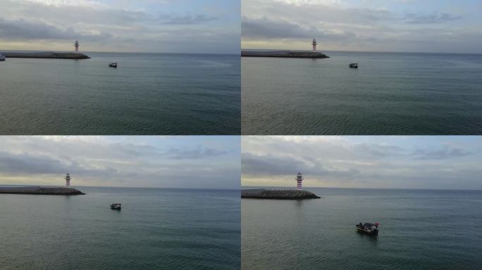清晨海边堤岸上的灯塔与渔船