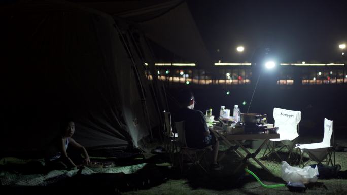 帐篷旁正在晚餐的小朋友