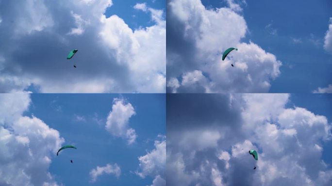 滑翔伞飞行在蓝天白云间