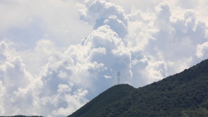 蓝天白云高山高压输电铁塔延时实拍