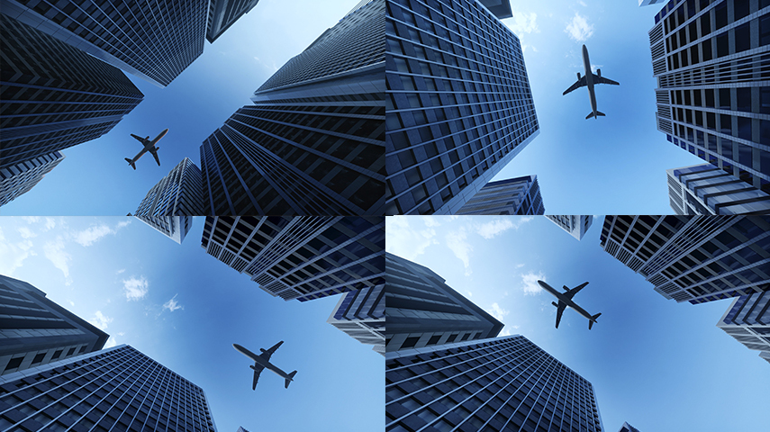 商务飞机飞过楼顶飞机起飞金融大楼科技感