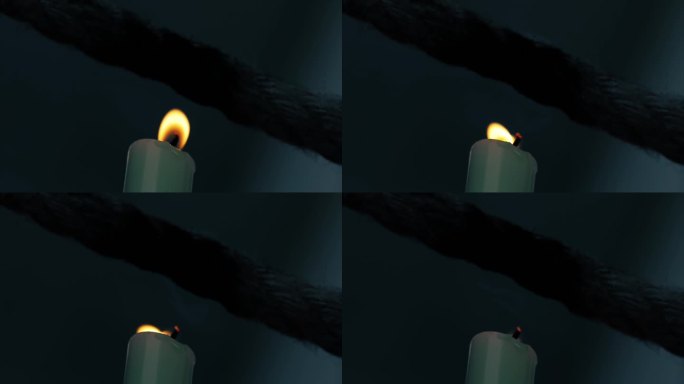 风吹熄烧绳子的蜡烛火苗
