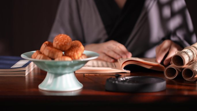 古代文人书房书桌上高脚瓷盘里中秋广式月饼
