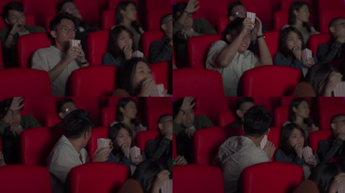 一名亚裔中国年轻人将爆米花倒在其他观众身上，惊悚的电影场景让他们大吃一惊