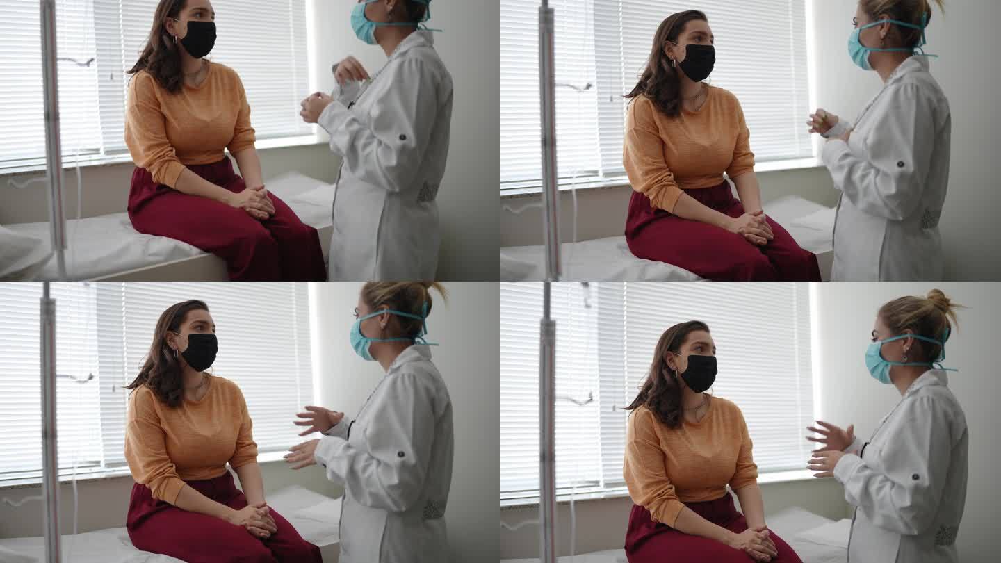 患者在医疗预约时与医生交谈-戴防护面罩