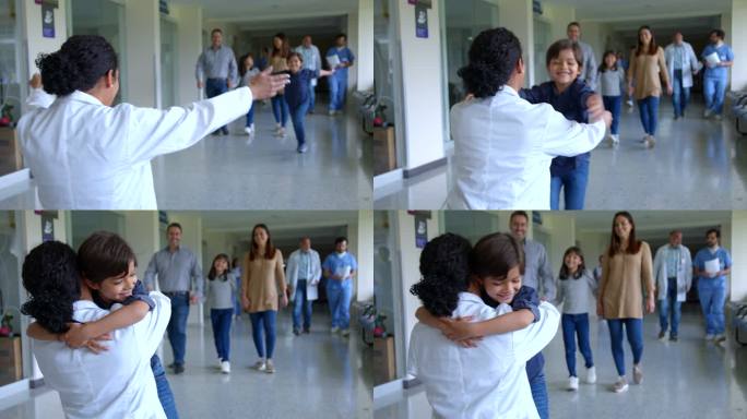 一个可爱的小男孩在医院走廊跑来，非常亲切地拥抱他的儿科医生