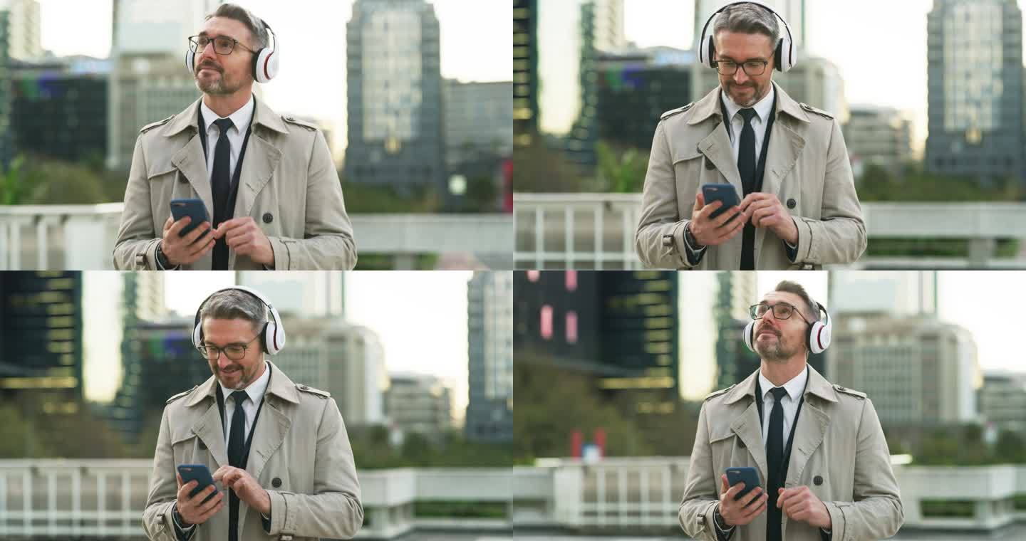 一个成熟的商人戴着耳机和手机在城市里行走的4k视频片段