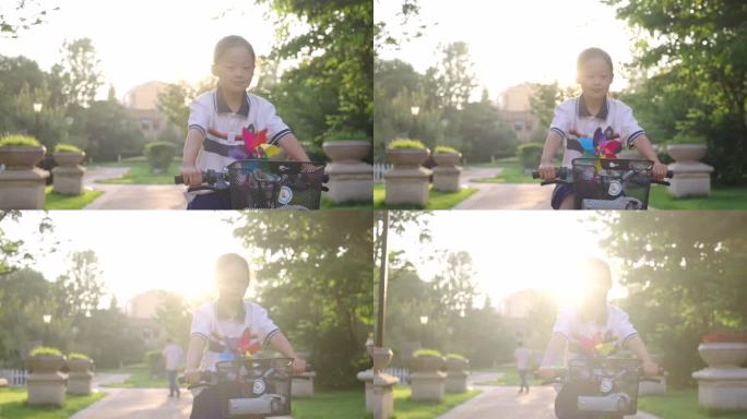 夕阳下骑单车小女孩-童年快乐美好生活